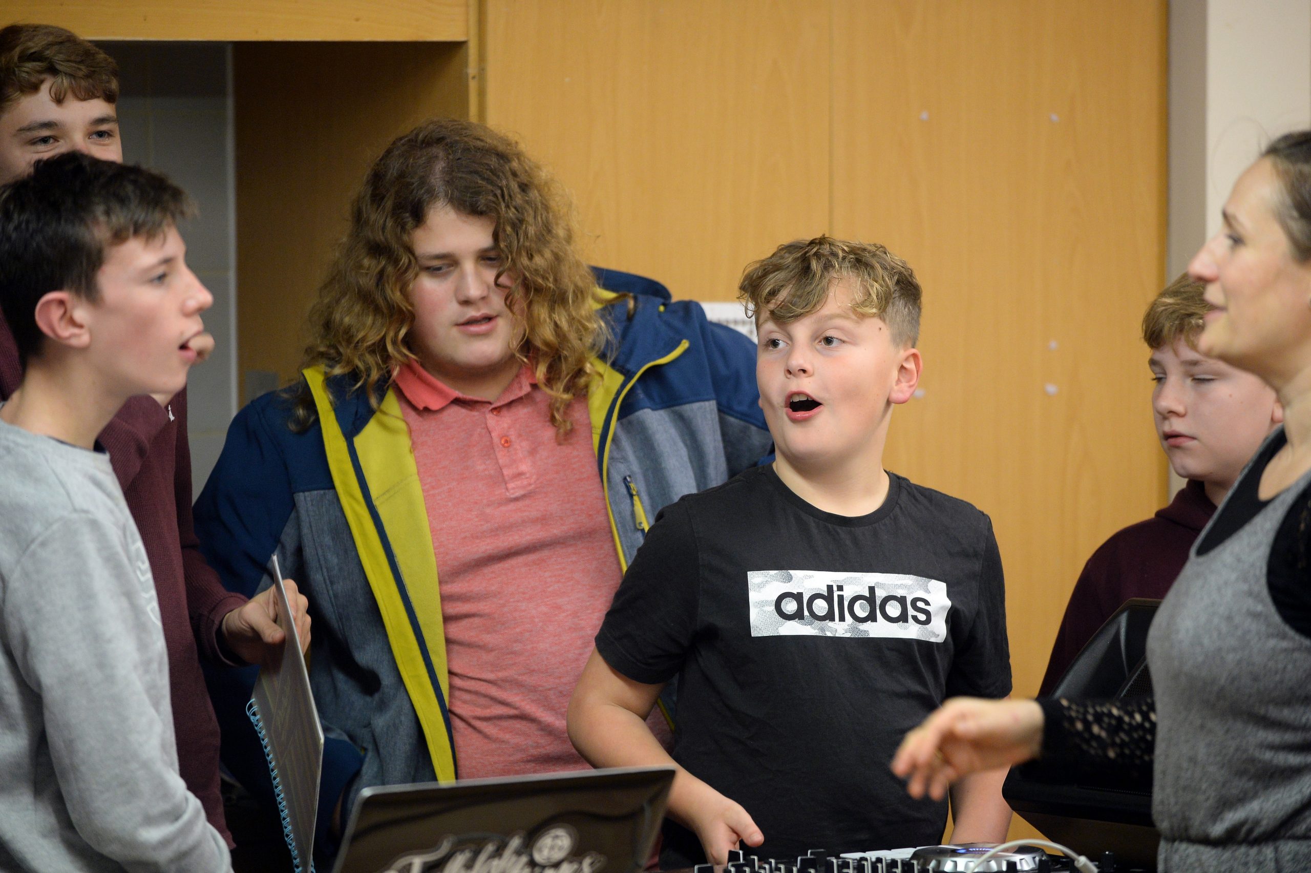 A group of young people in a DJ session with tutor, Sophie Tott