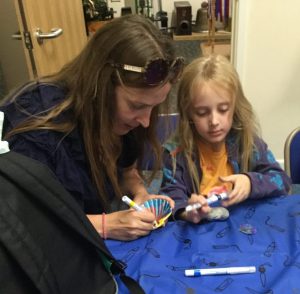 Mother and daughter decorating shells in a creative session at Lowestoft Maritime Museum