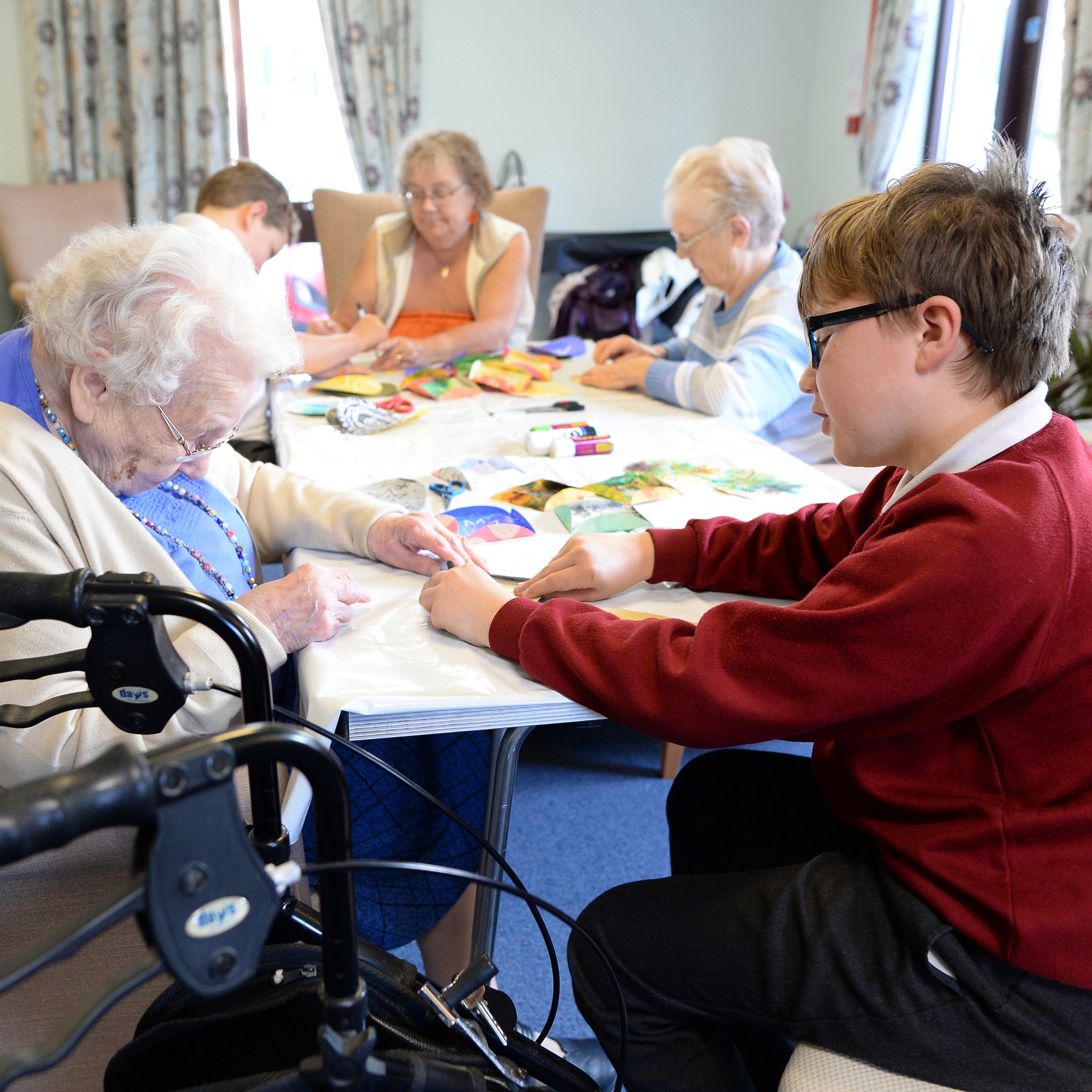 School pupil working together with care home resident