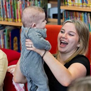 Adult and baby in library session