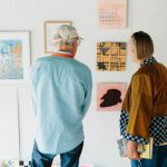 2 people looking at artwork in the gallery