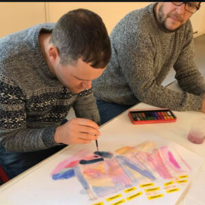Brave Art student, Daniel, painting his name in watercolours