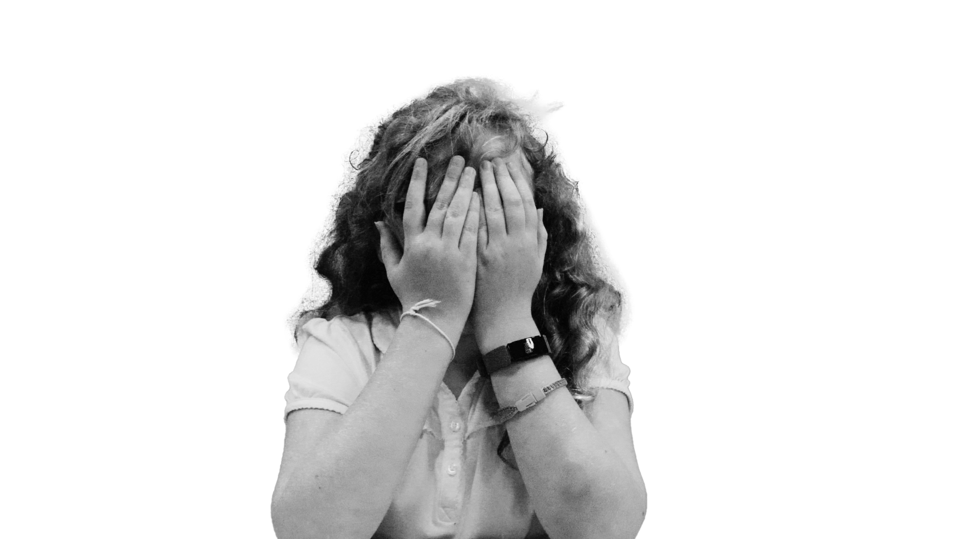 Monotone image of child, covering her face with her hands