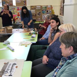 A group of our Let's Get Creative participants, thinking about and working on the Stradbroke Tapestry.