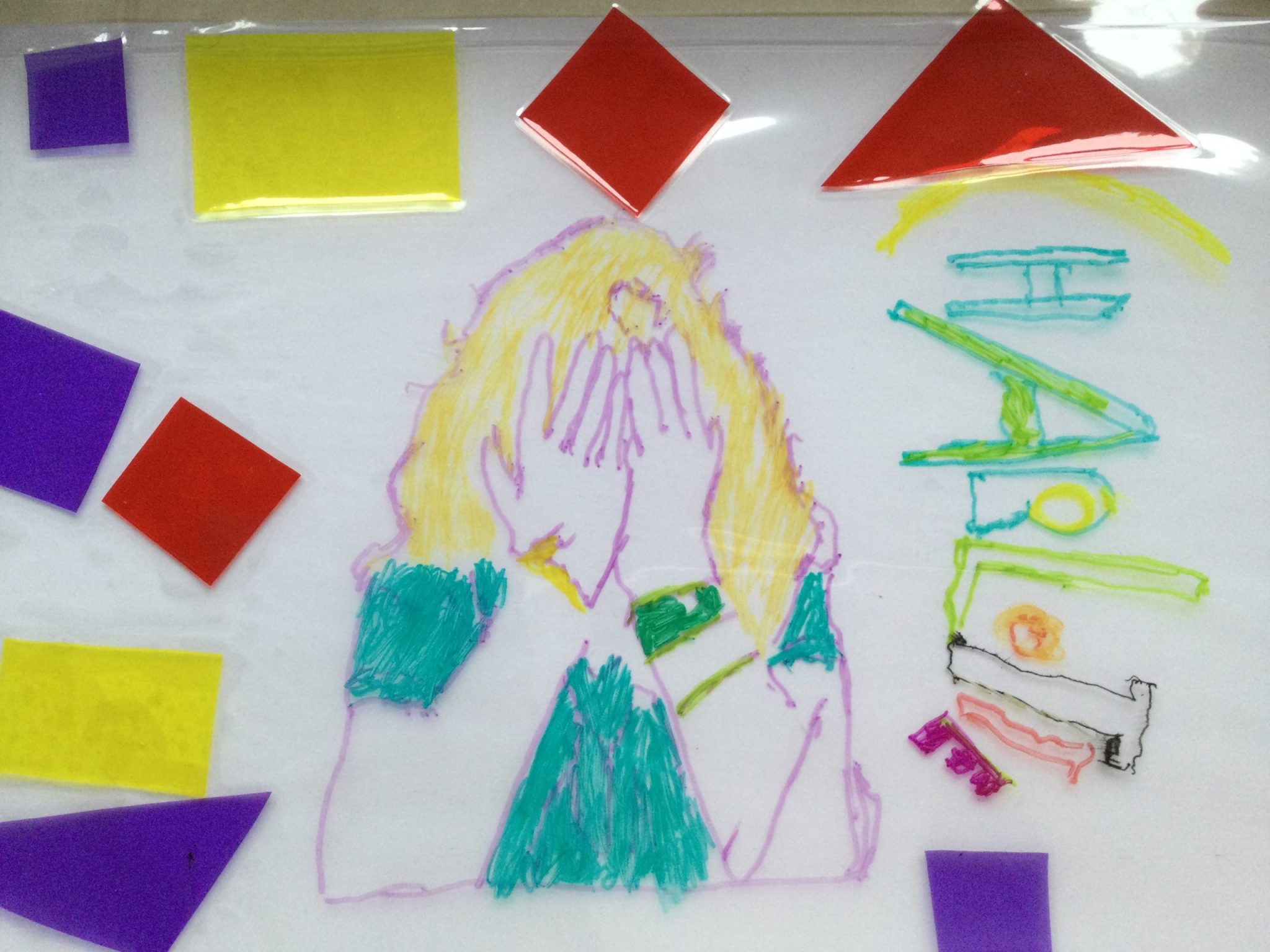 A colourful picture of a child's face, drawn on acetate