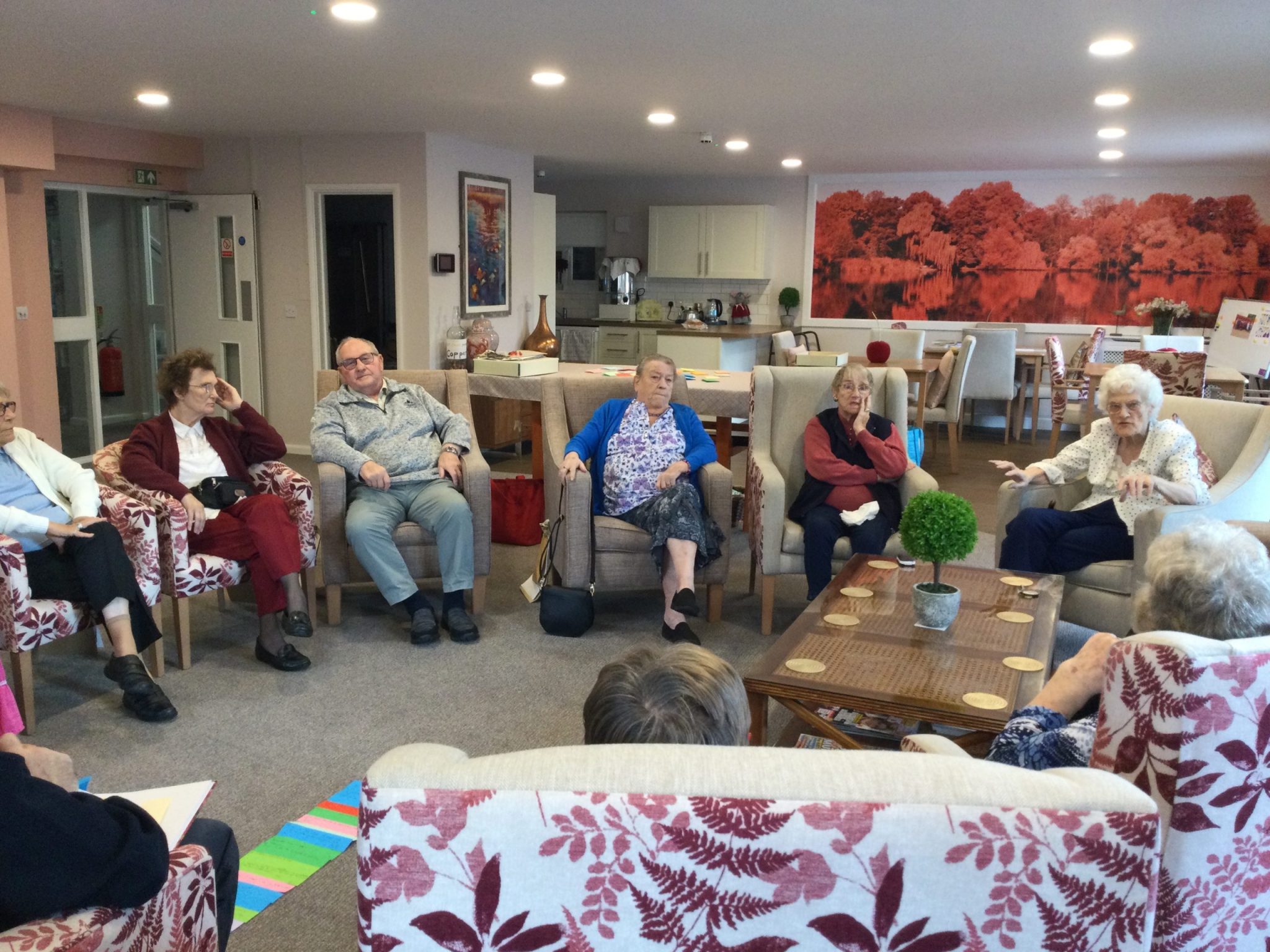 A group of adults seated in armchairs