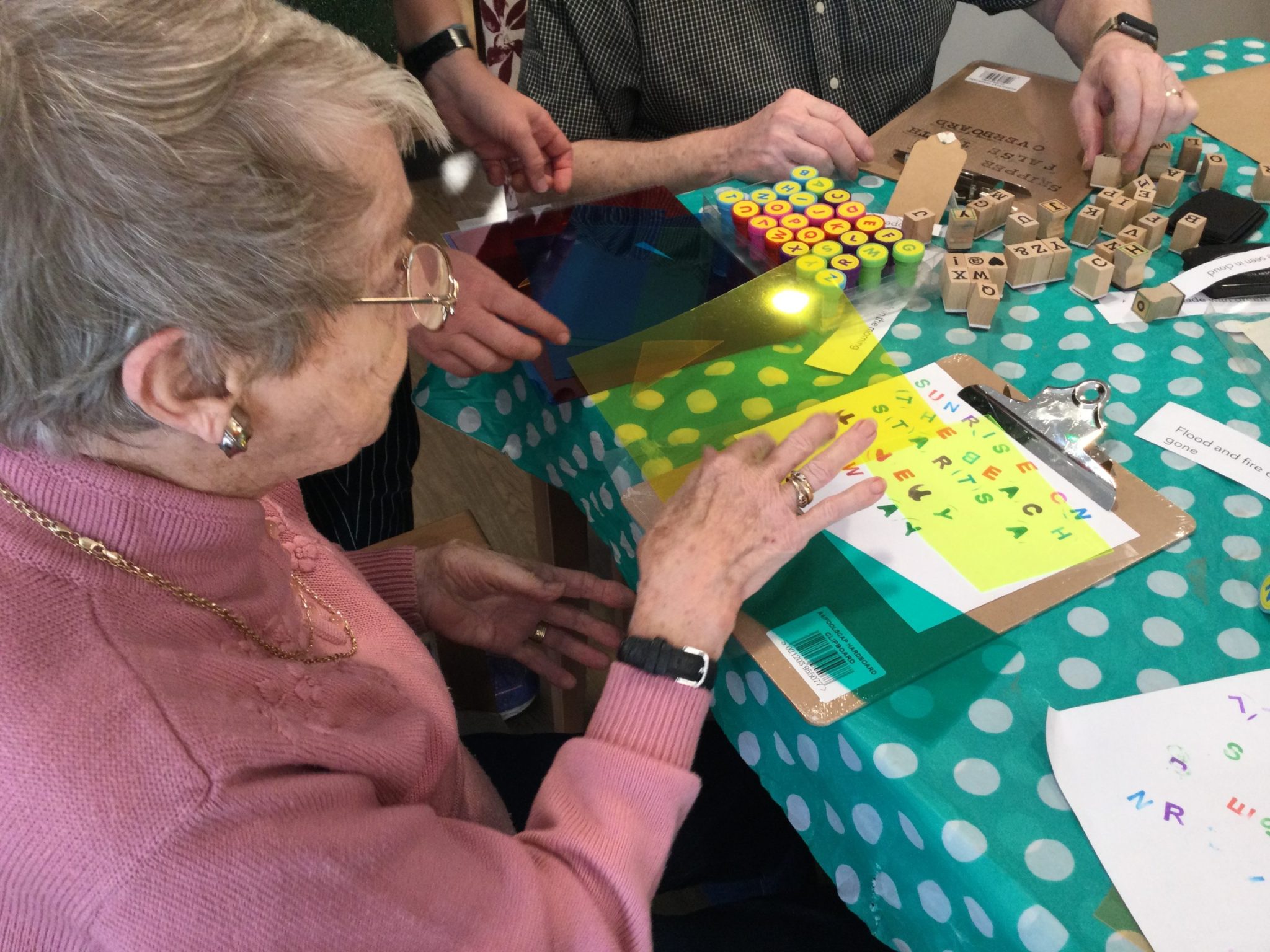 A pair of adults, using printing blocks to stamp our headlines