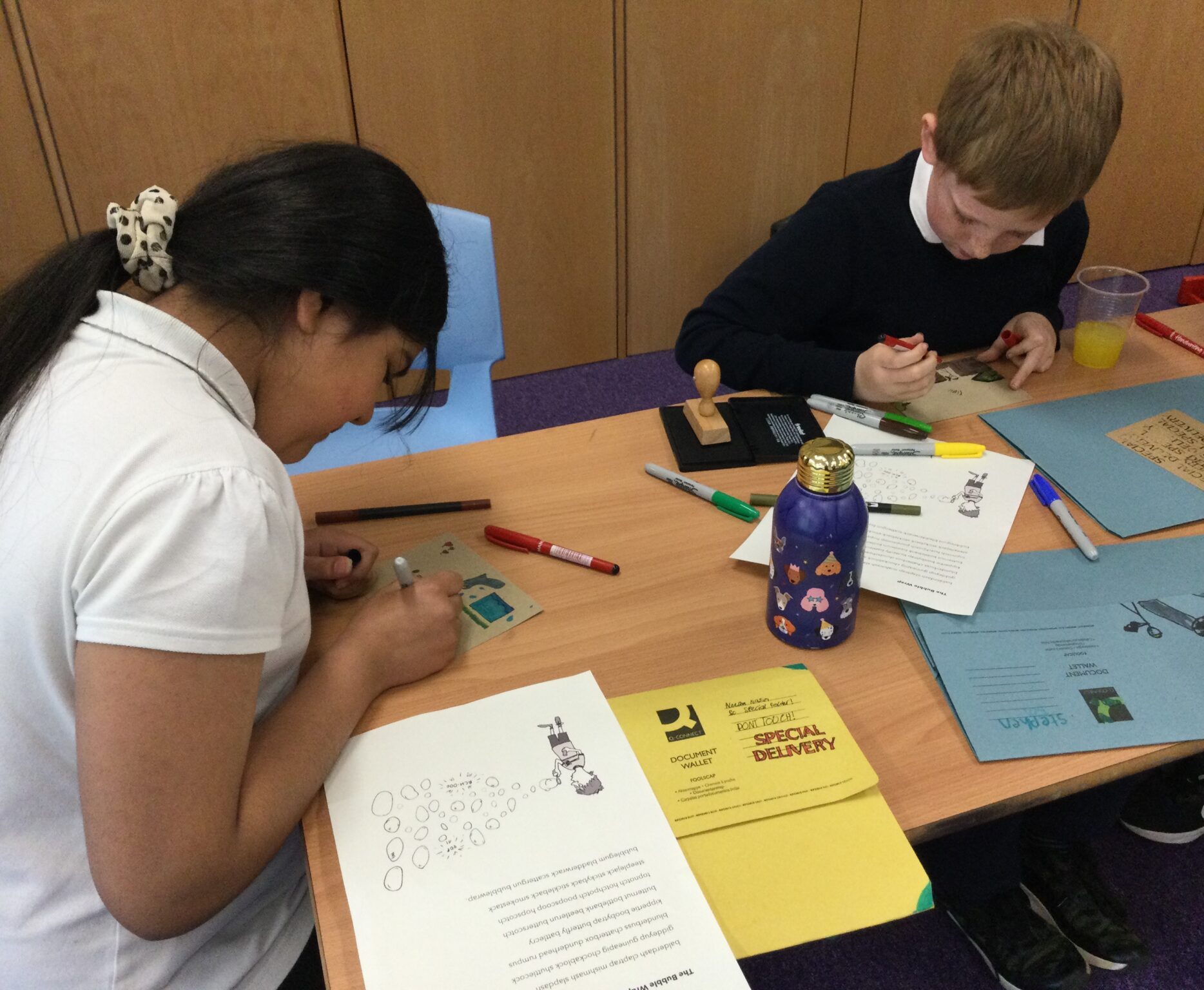 Children busy illustrating their postcards