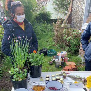 Kasia behind table of edible plants