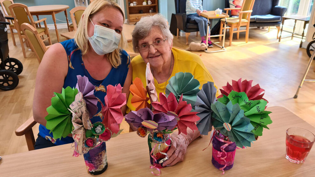 Staff and resident at Beech House posing with the flowers