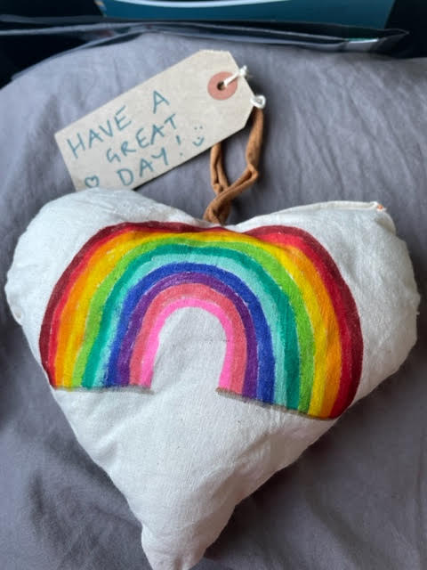 White heart with a rainbow on it and tag which says 'Have a great day! smiley face'