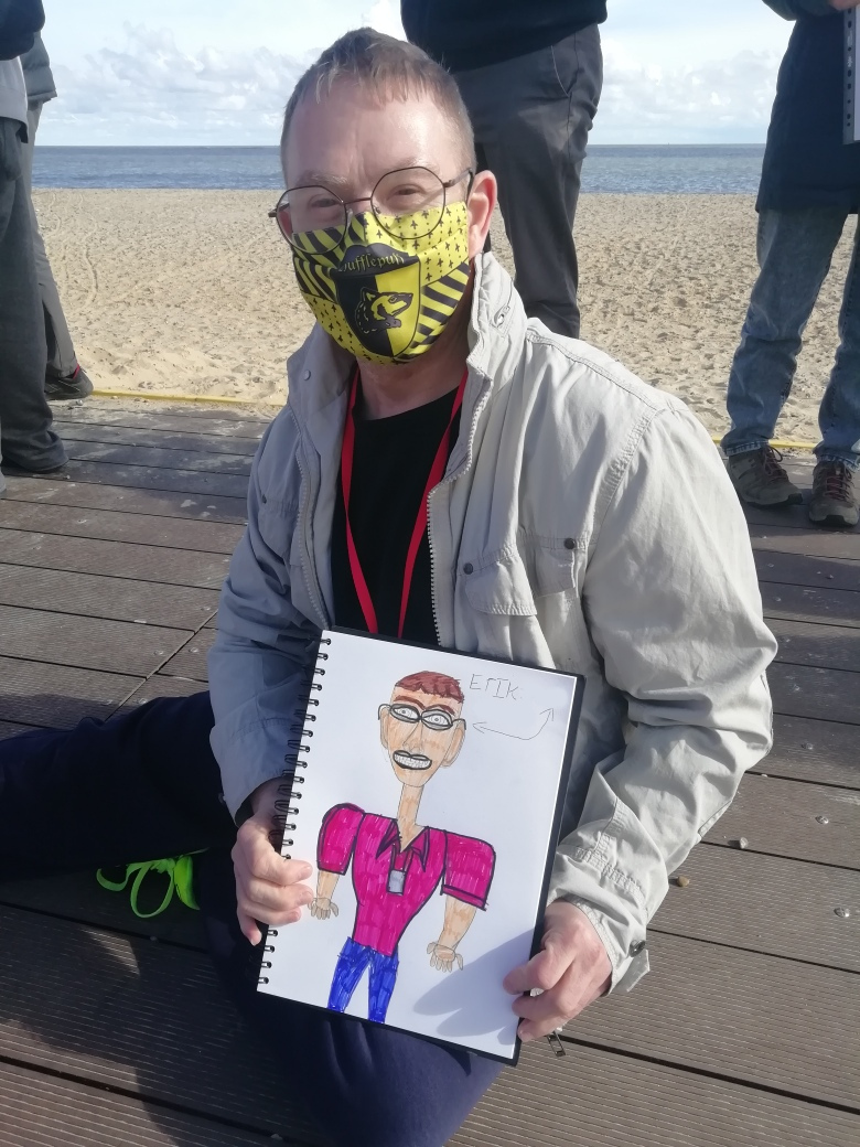 Student Erik shows his picture 'Our Amazing Self' whilst at Lowestoft beach