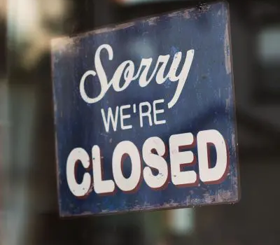 Sorry we're closed sign in a shop window