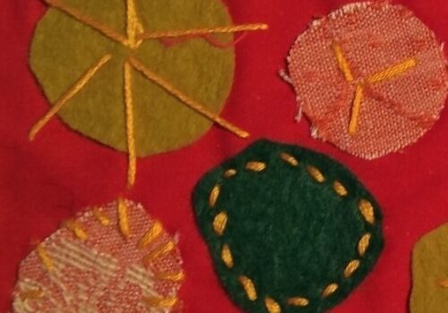 Round circles with stitched designs on red background