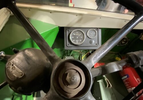 Imagineering Journey Bus driver seat view of cab through steering wheel.