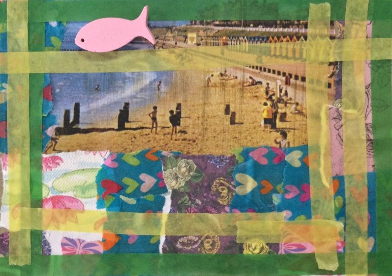 A collaged postcard with a back ground view of children in swimsuits on a sandy beach and overlaid with a border of yellow and green tape, decorative paper along the bottom and a small wooden pink fish glued on the left hand corner