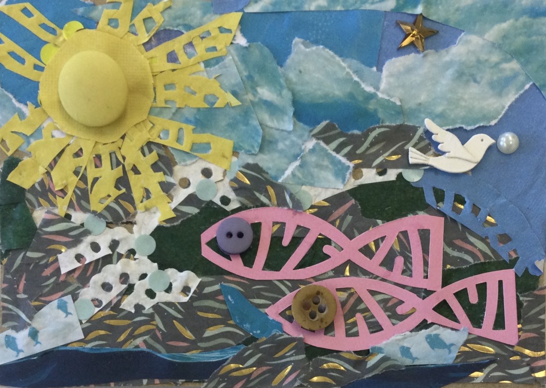 A collaged postcard with a background of numerous small pieces of blue and gold patterned papers with a large yellow sun in the lefthand corner, a tiny white bird and pearl to the right and two pink fish with button eyes below