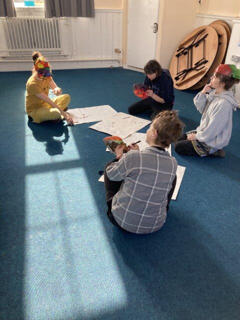 workshop participants sitting on the floor