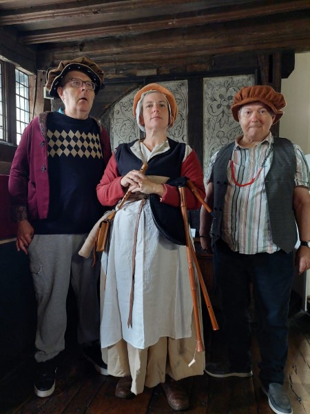 Three people in Tudor costume