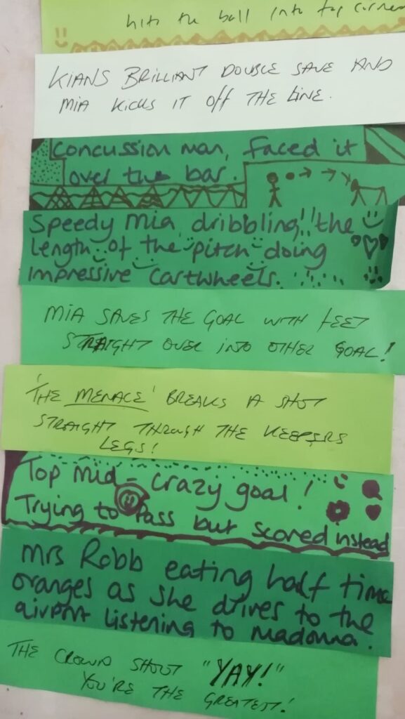 A series of strips of green paper stuck together, each strip with a hand written line of verse on it referencing football