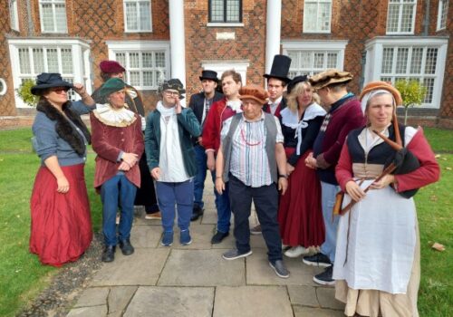 A group of participants and staff in Tudor costume