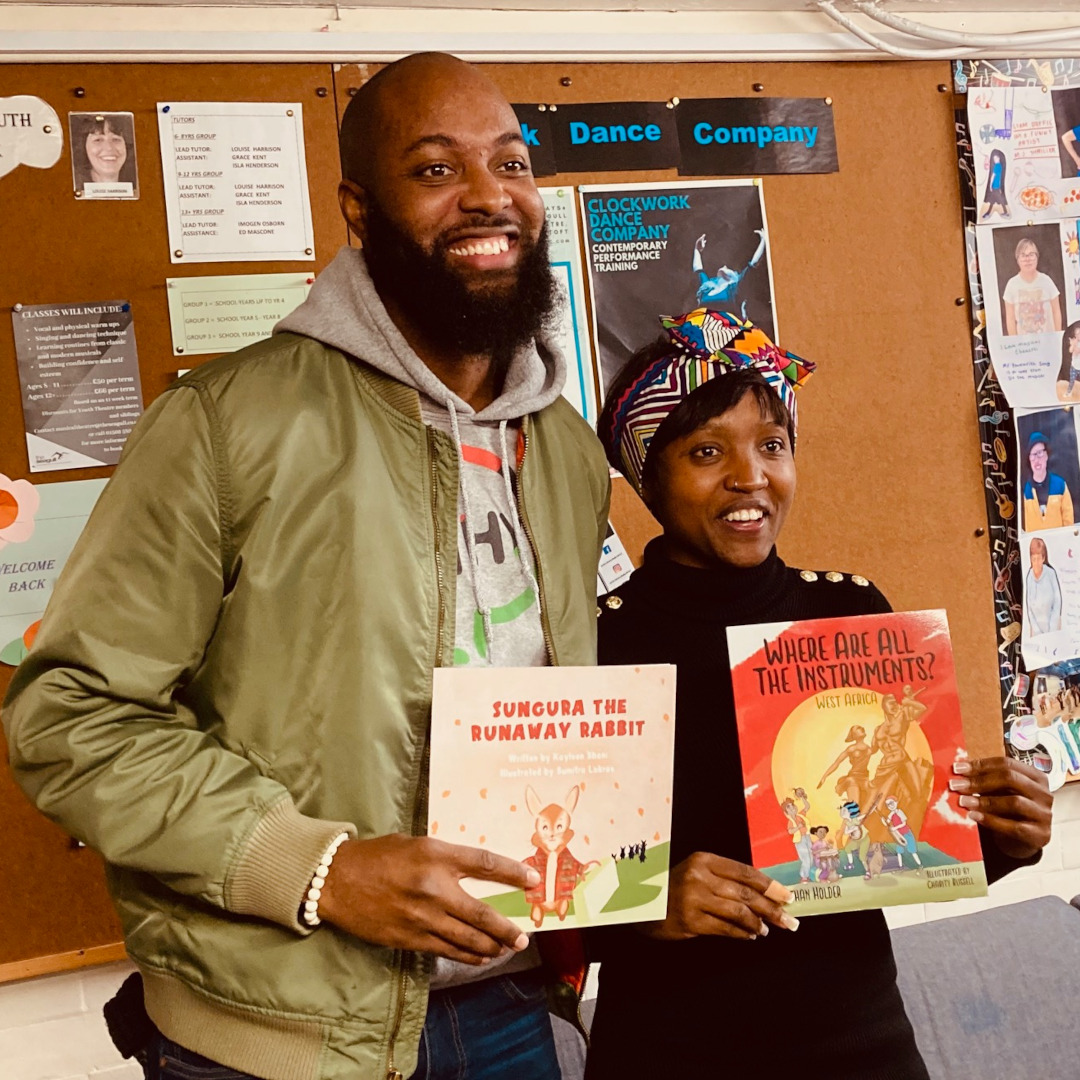 Authors Nate Holder and Kayleen Shani exchange their children's books Sungura the Runaway Rabbit and Where are all the instruments? West Africa.