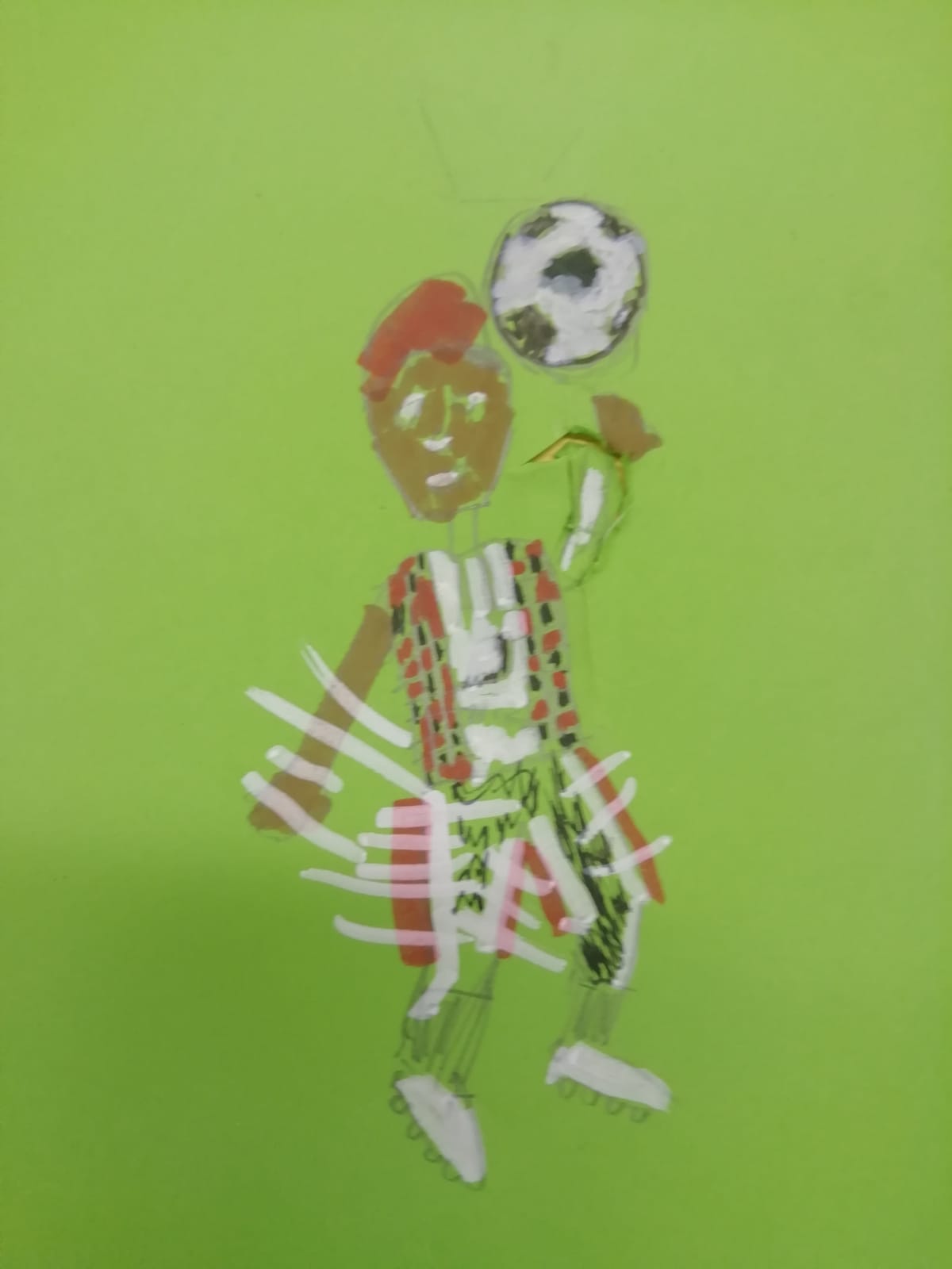 A cartoon of a footballer with red hair, wearing red, black and white kit and white boots, flicking a black and white ball in the air