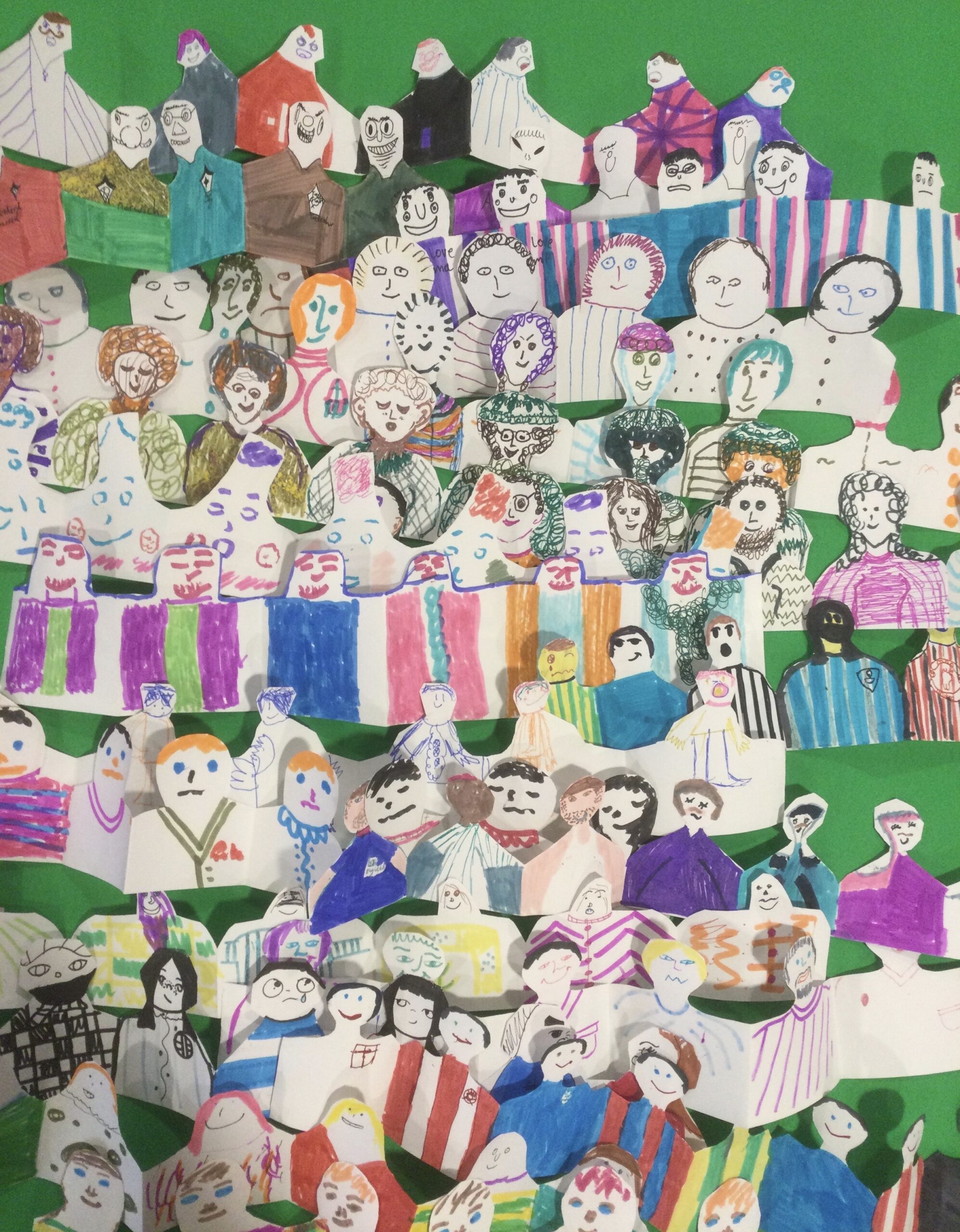 Rows of colourful cut-out paper figures on a green background
