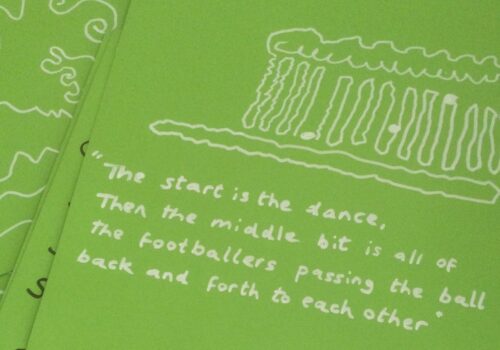 Green paper white inked drawing with words The start is the dance then the middle bit is all of the footballers passing the ball back and forth to each other