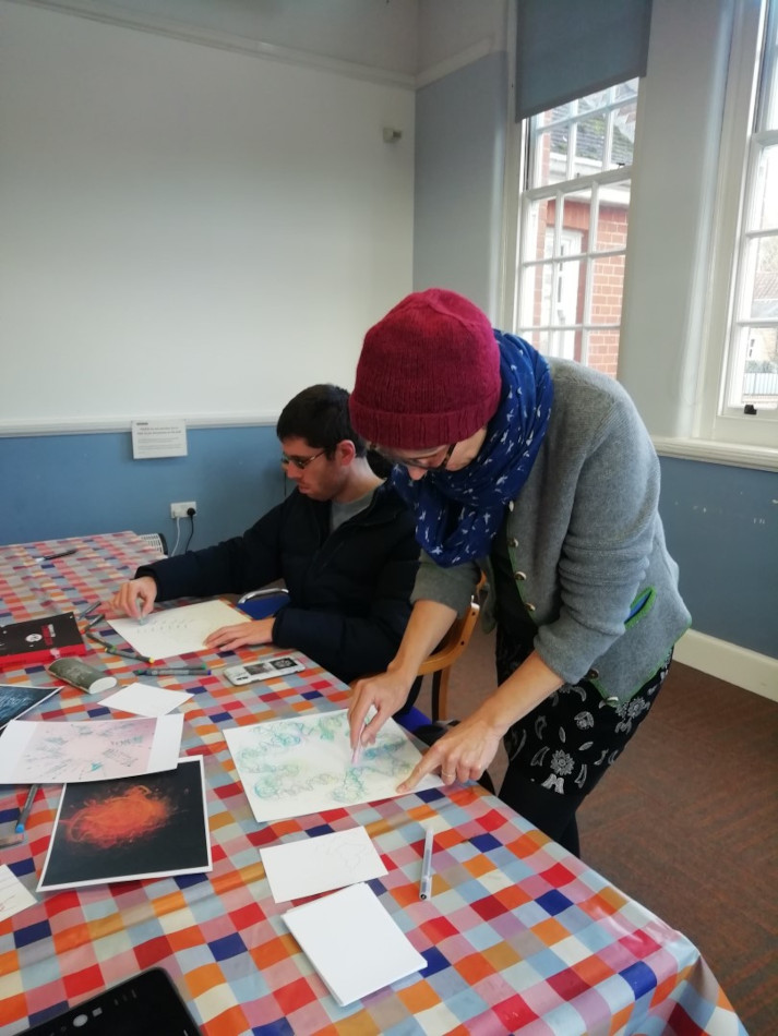 Two people painting at a table