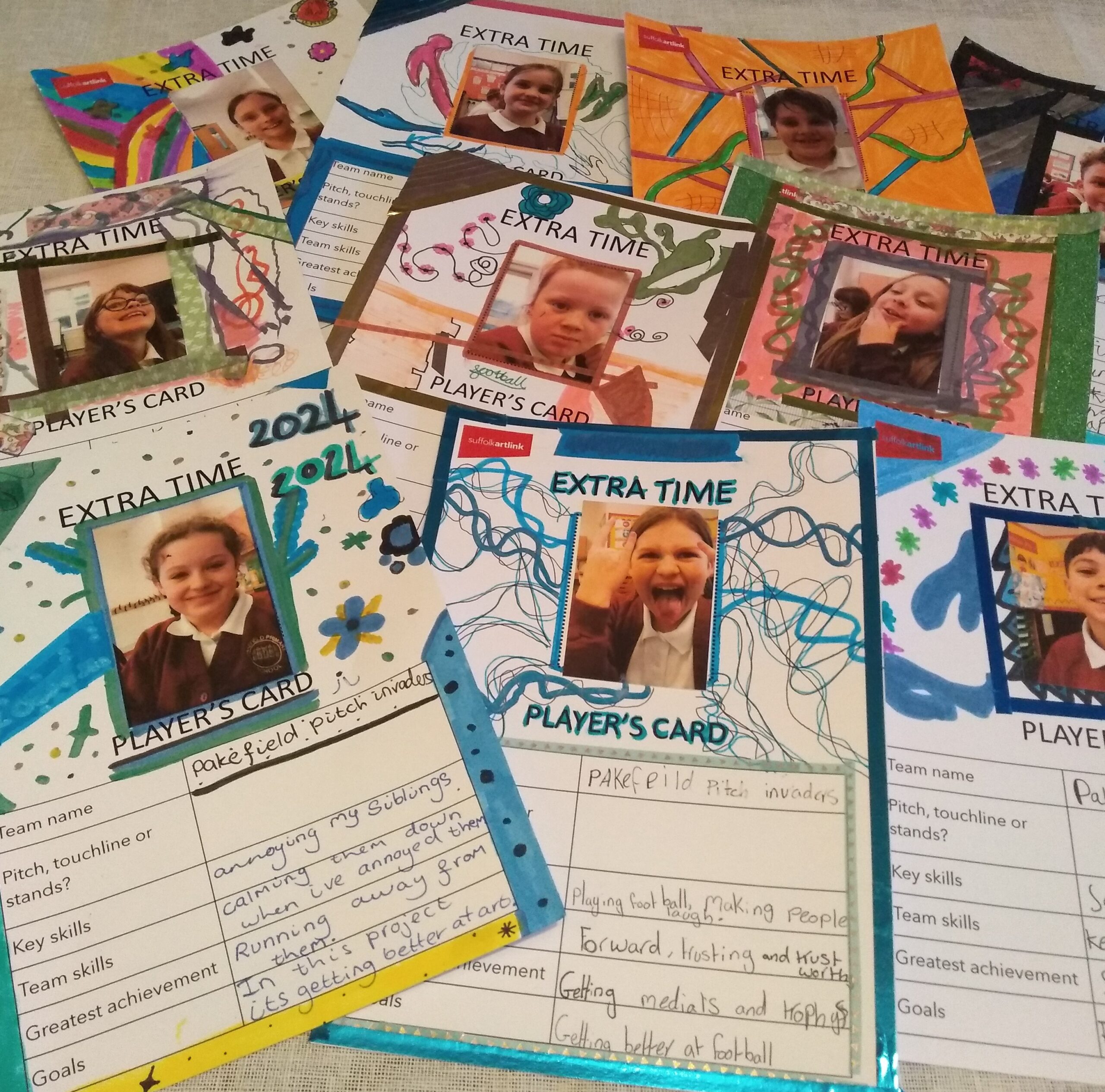 A collection of cards, each with a photo of an individual child, decorated and listing skills, achievements and goals