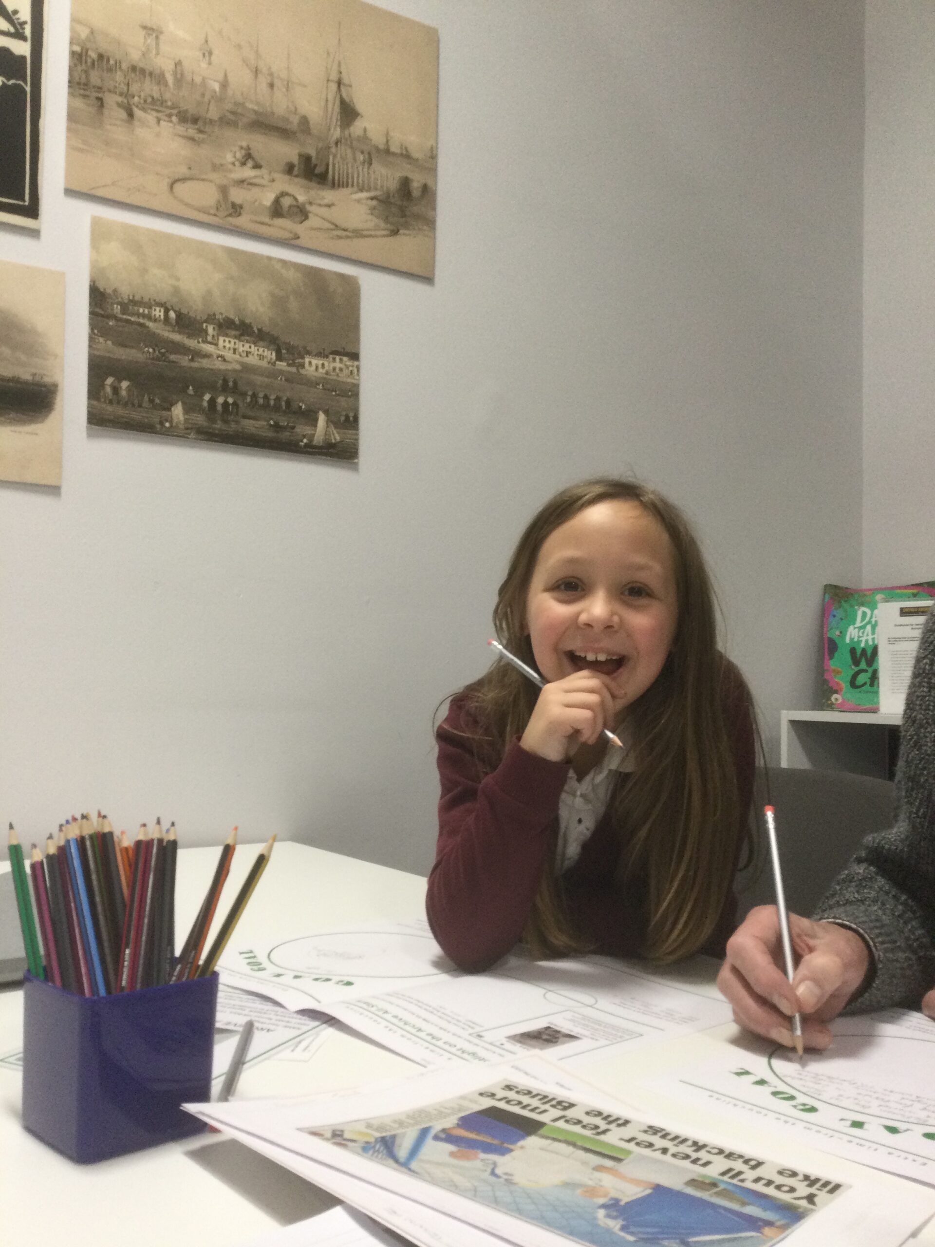 A young girl grins to the camera