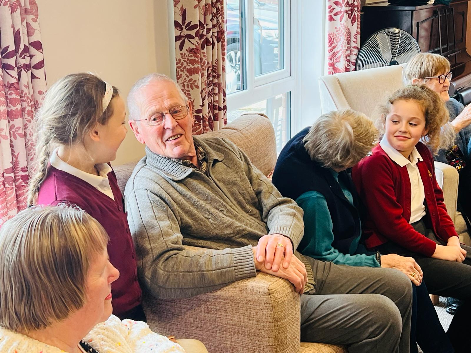 A group of adults and children chatting together