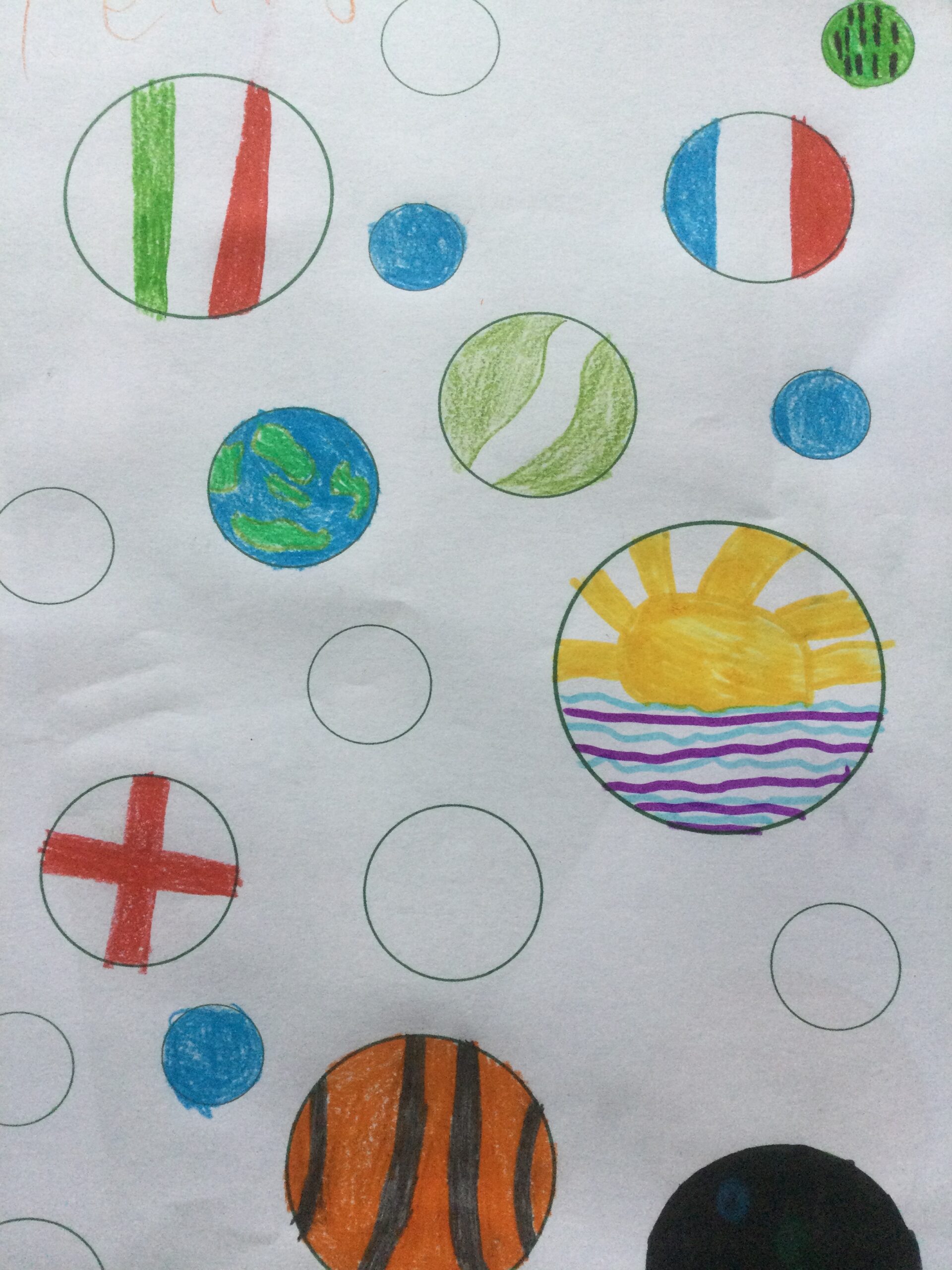 Printed circles decorated in different colours with one looking like a sunrise over the sea