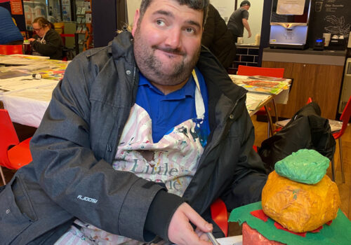 Artist Josh with his pop art sculpture of a Sloppy Joes burger