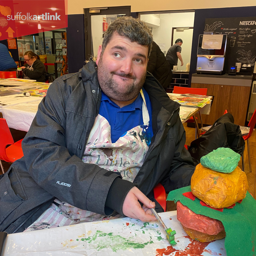 Artist Josh with his pop art sculpture of a Sloppy Joes burger