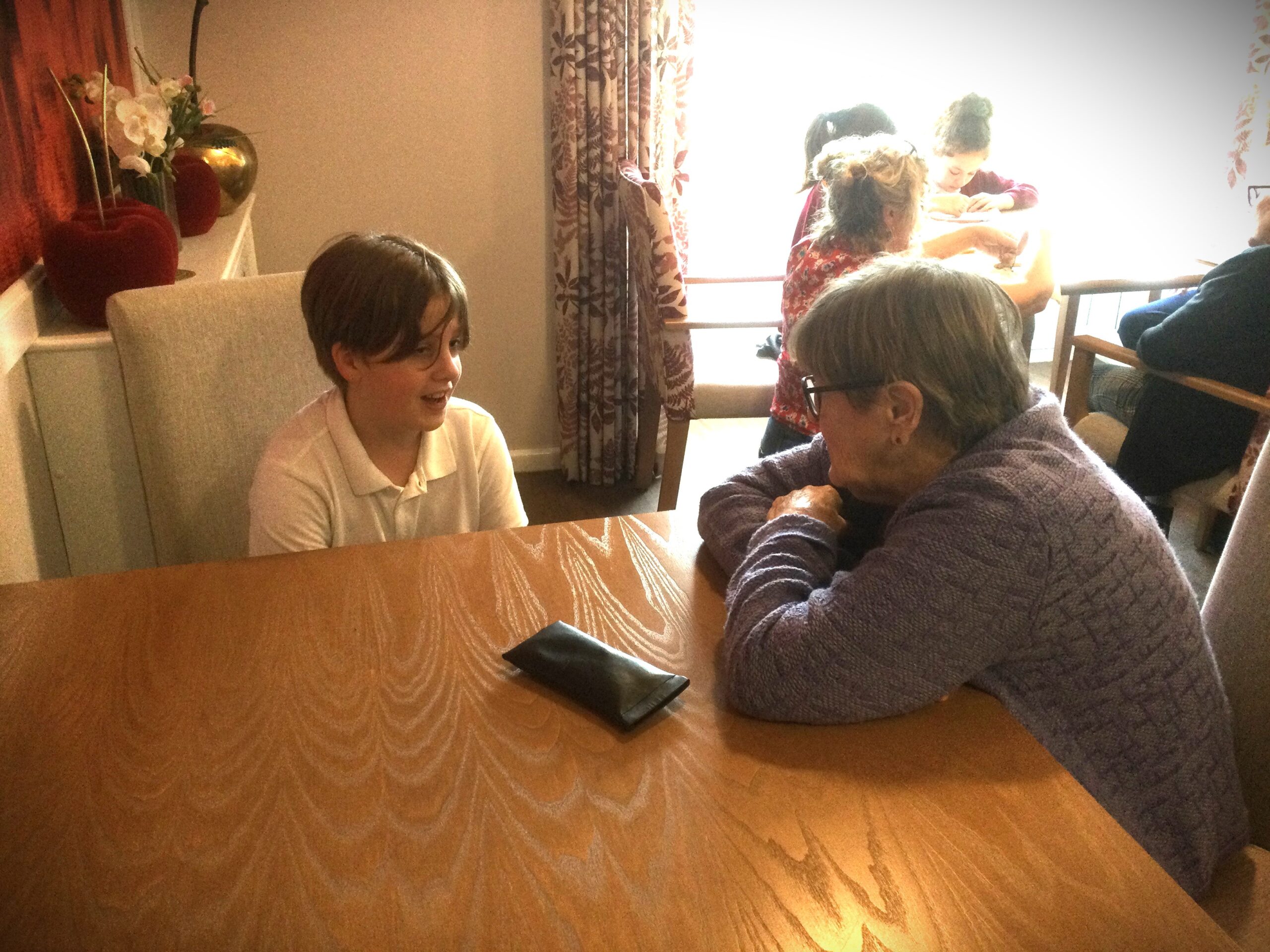 A school boy and adult engrossed in conversation