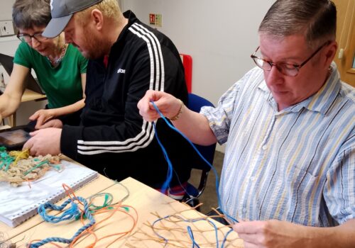 3 people making model fishing nets