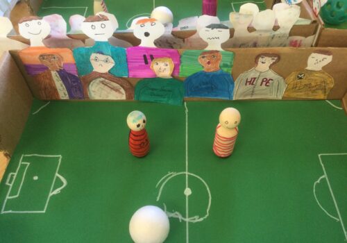Table top football games with players, spectators and white ball