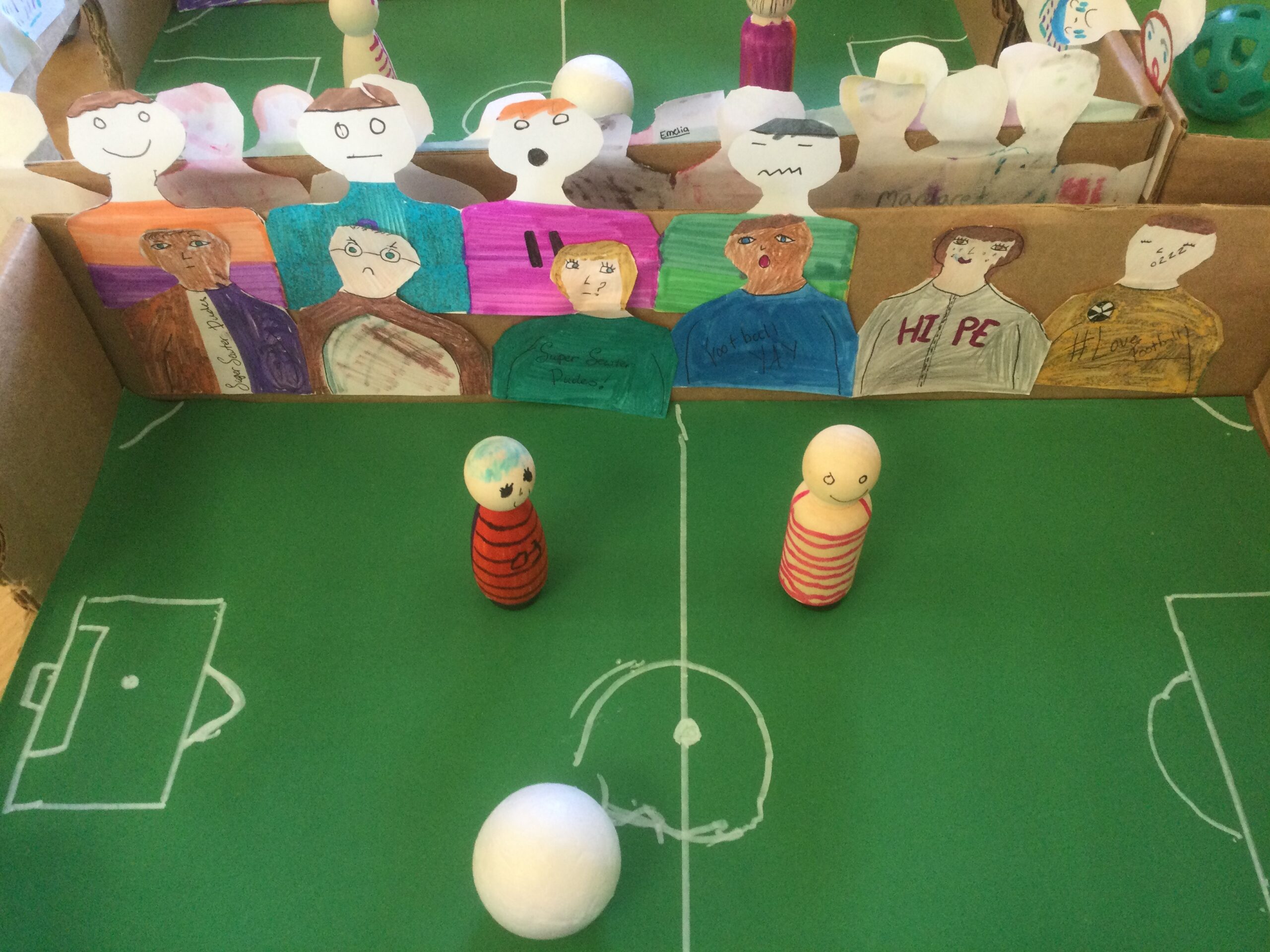 Table top football games with players, spectators and white ball