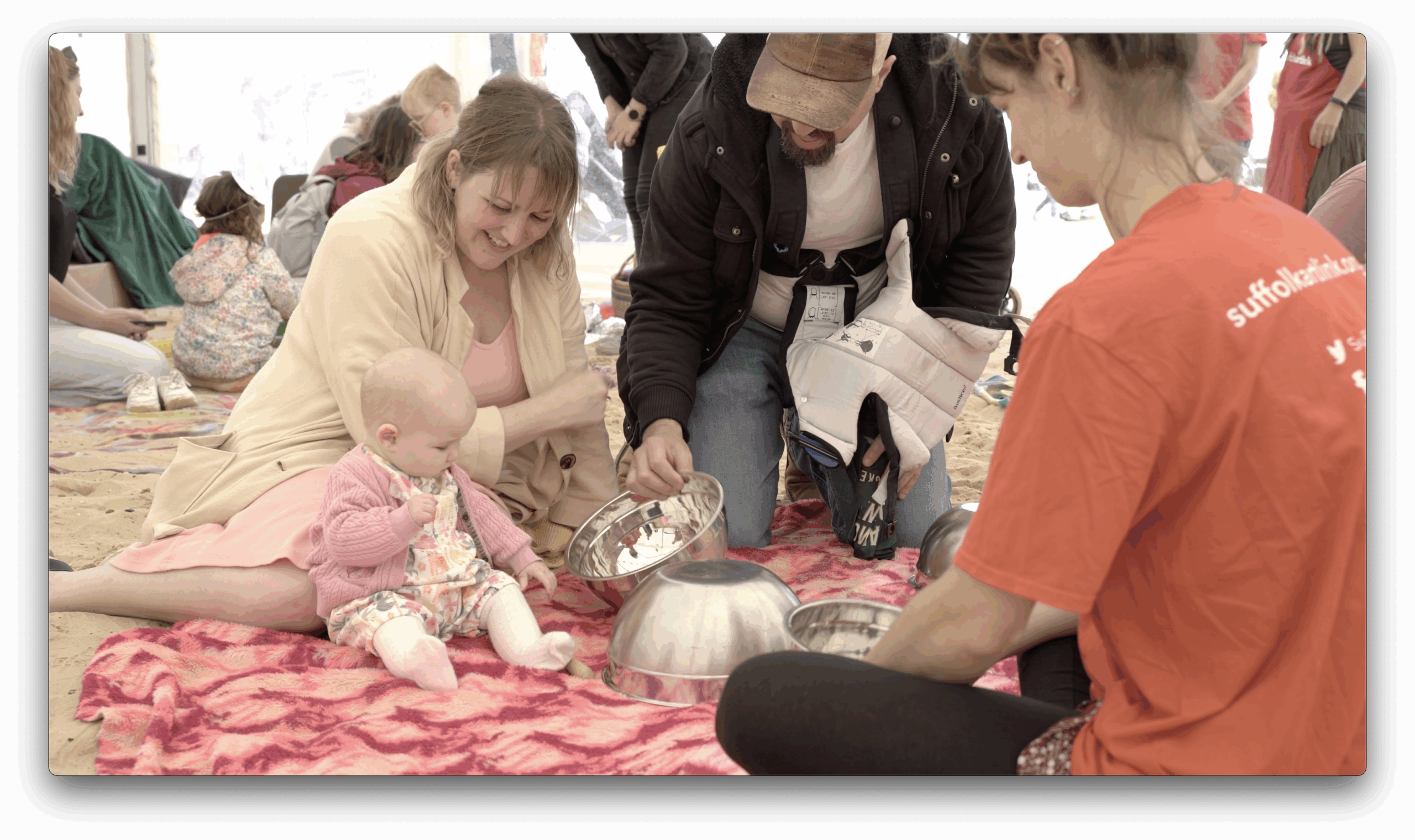 Parents and baby playing with silver bowls