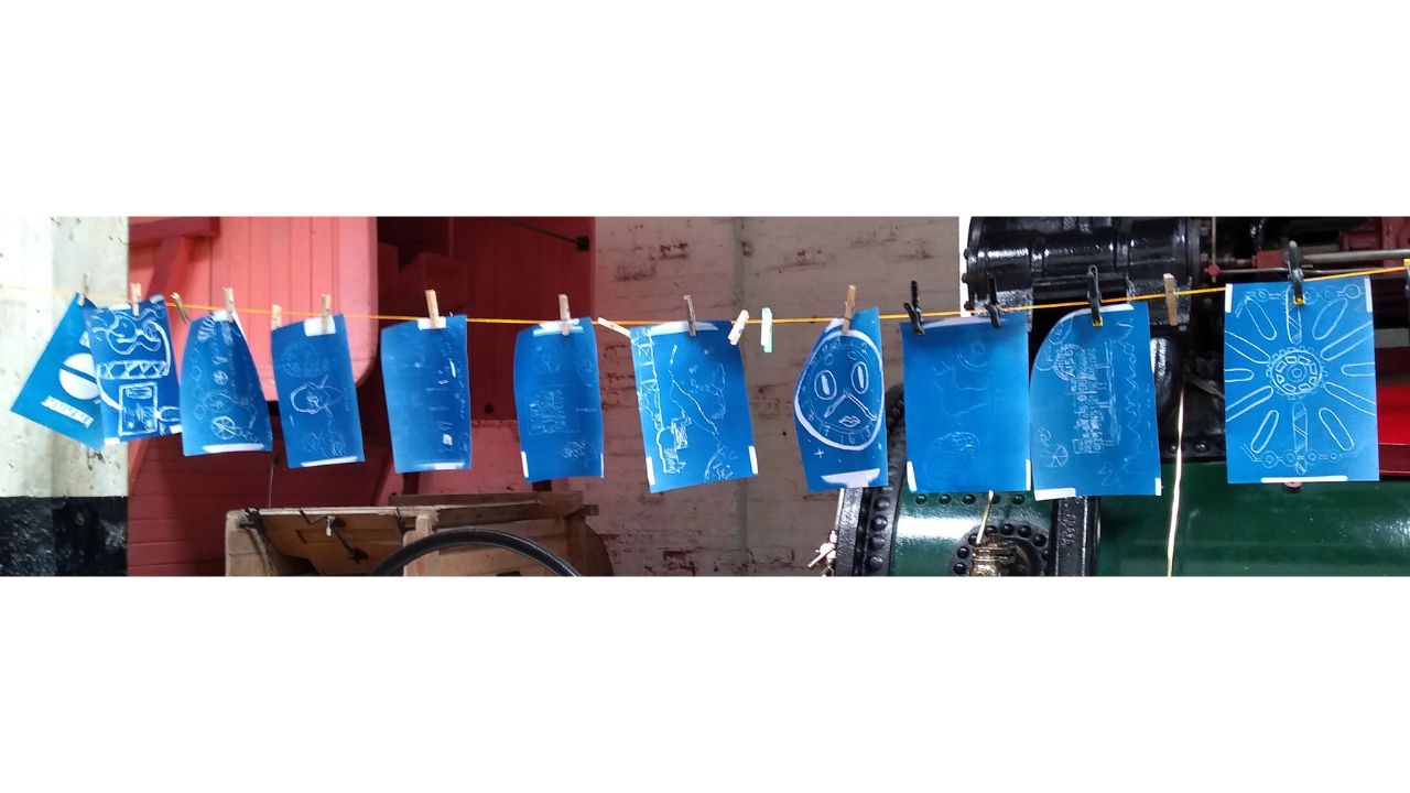 11 blue and white pictures hung up to dry