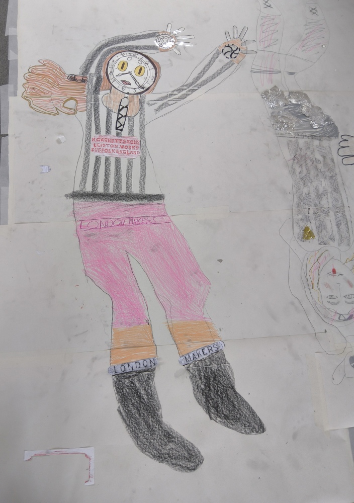 A life-sized drawing of a footballer with black and white striped top, clock face and pink leggings London Makers printed on band around socks