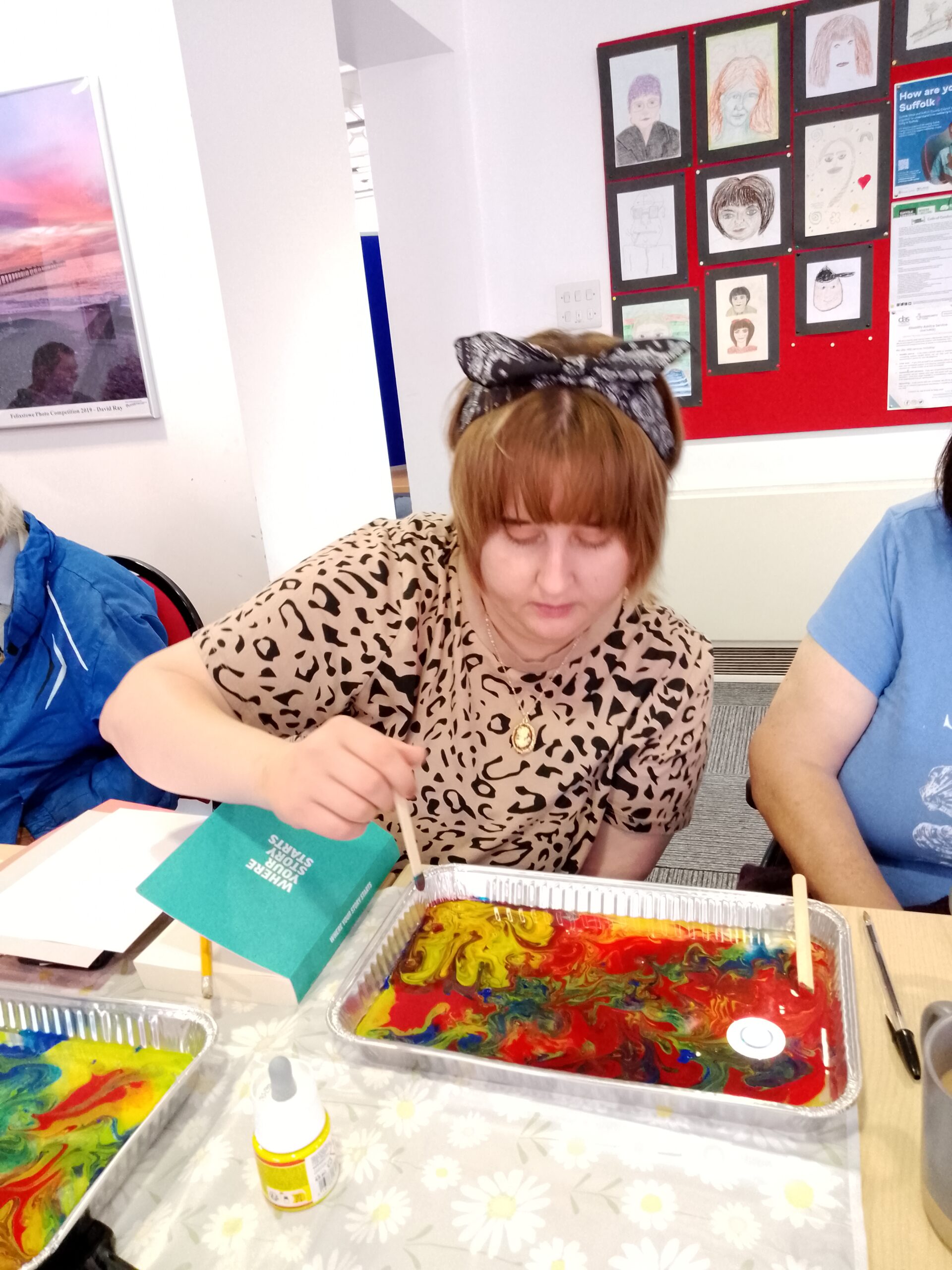 Participant experimenting with a marbling technique