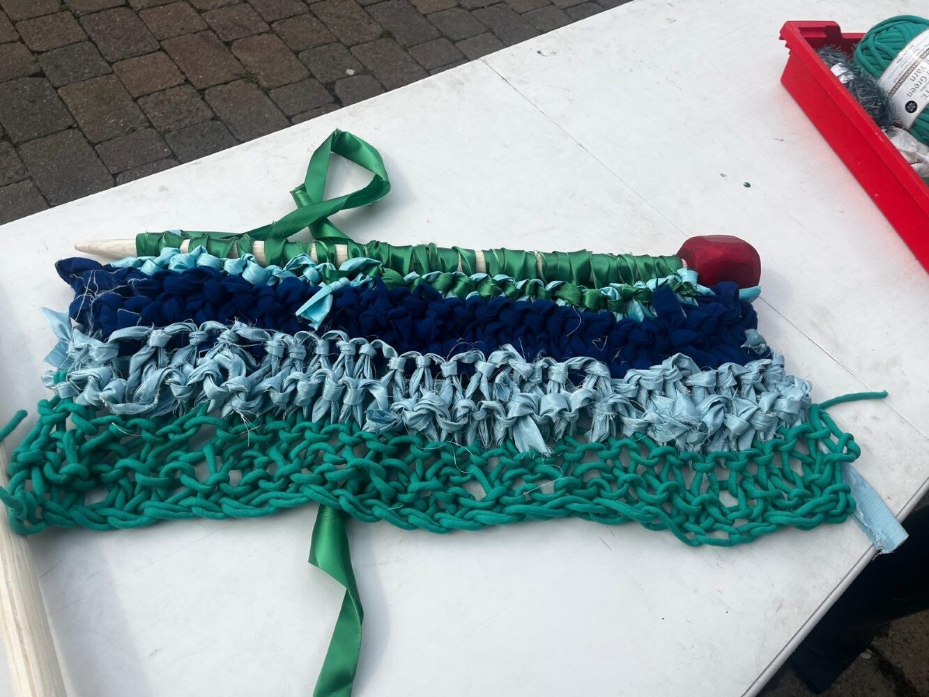 Rows of knitting on the huge needle
