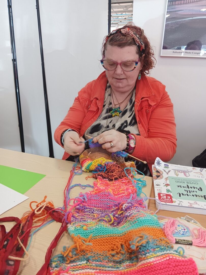 woman knitting a long scarf