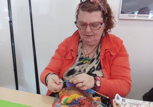 A woman knitting a scarf