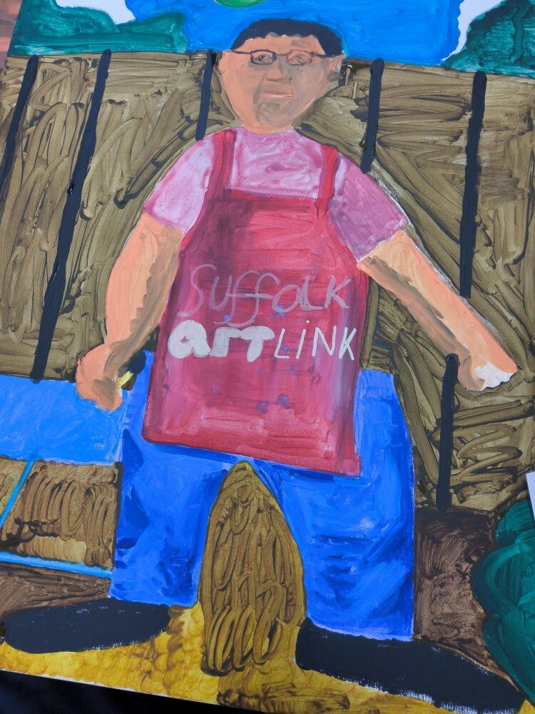 A large canvas in blue, green brown and red, depicting a man wearing glasses. He has a light red top, blue trousers and a red apron bearing the words Suffolk Artlink