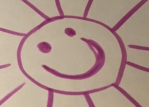 Purple cartoon sun drawn in felt tip