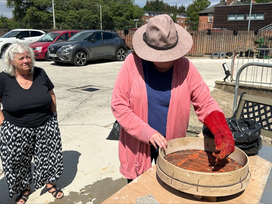 Participant sifting sand